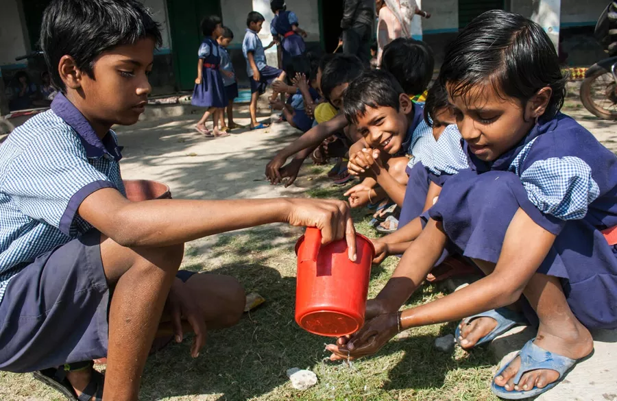 Volunteer explaining handwashing and hygiene to children